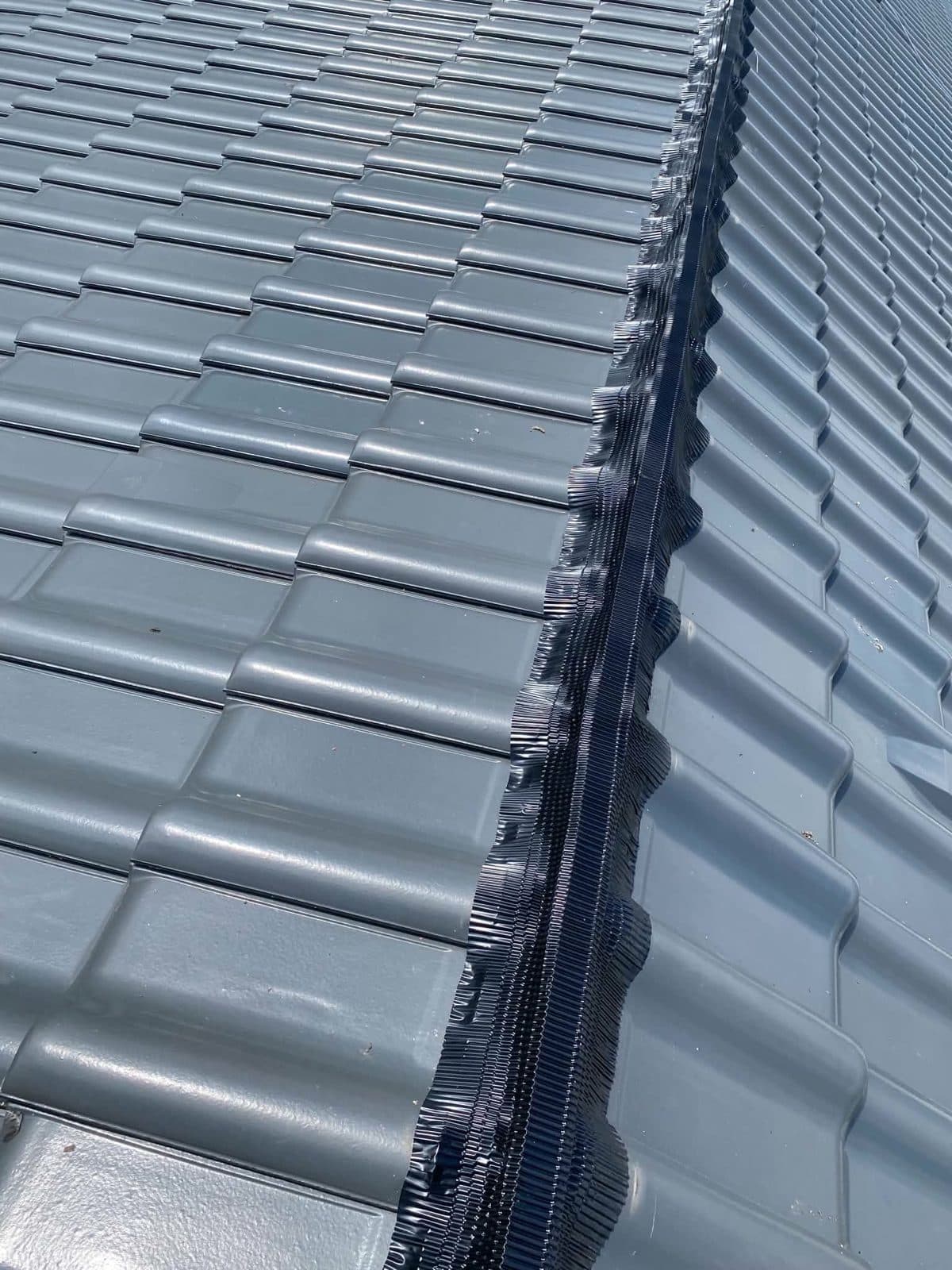 Detaliu coamă la un acoperiș din țiglă metalică gri antracit